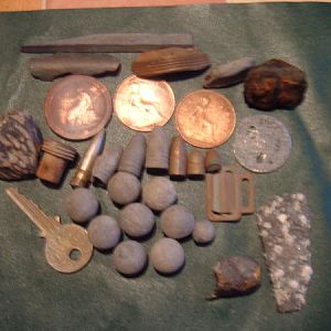 Assorted coins munitions and metal object.