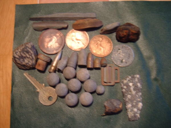 Assorted coins munitions and metal object.